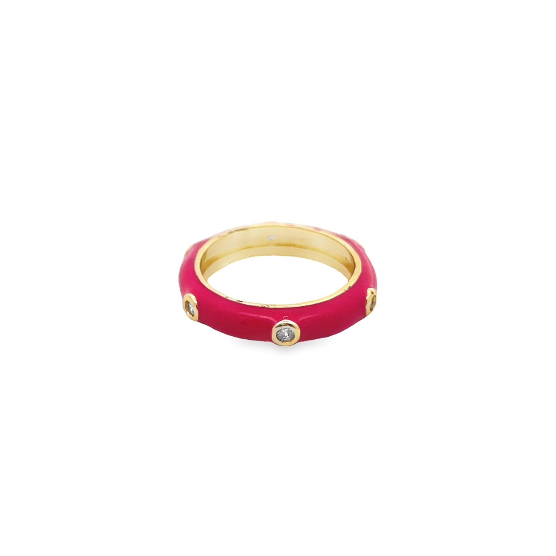 A vibrant pink enamel ring features inlaid sparkling crystals set in gold against a clean white background.