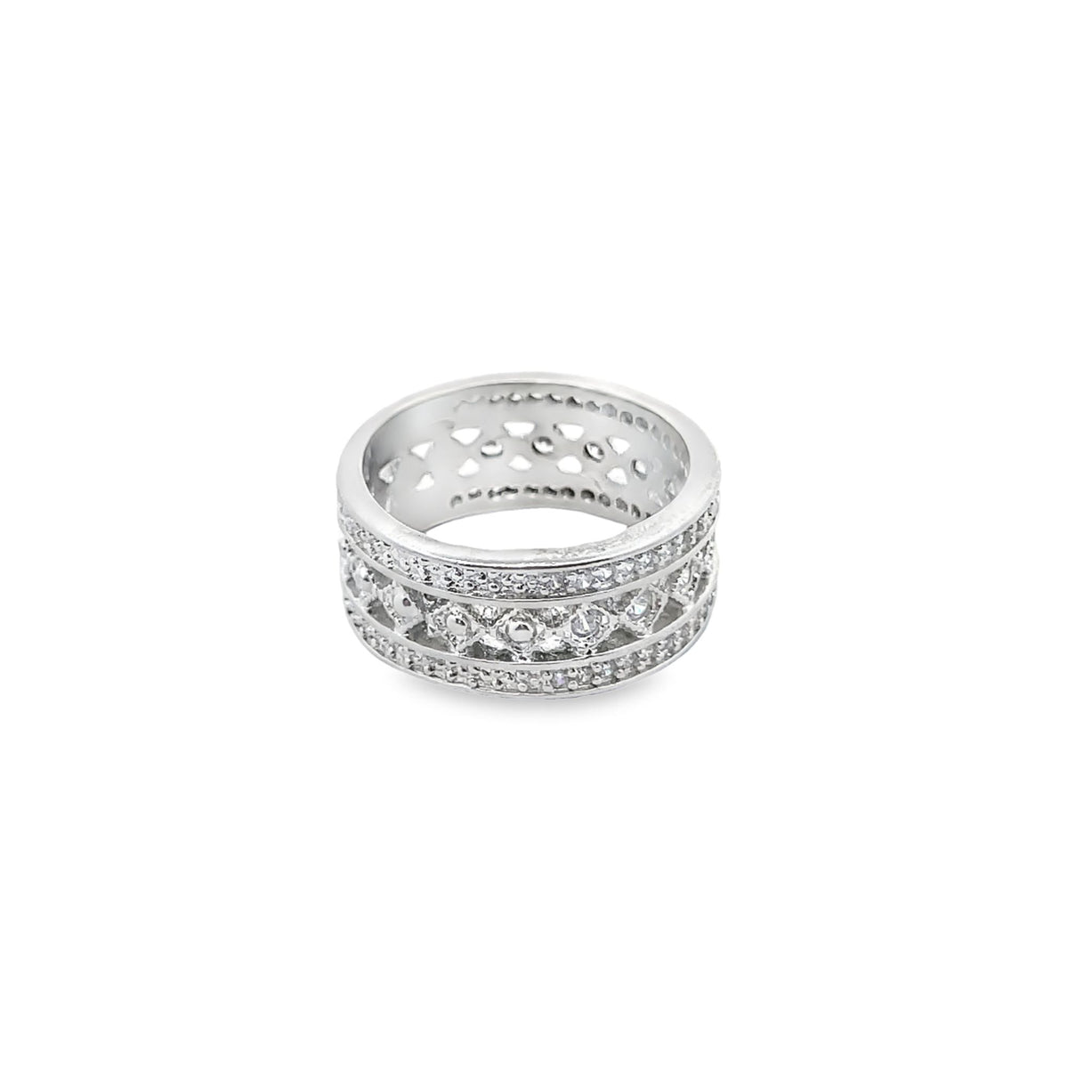 A wide silver band ring sparkles with pave-set cubic zirconia crystals and features intricate cut-out patterns along its surface.