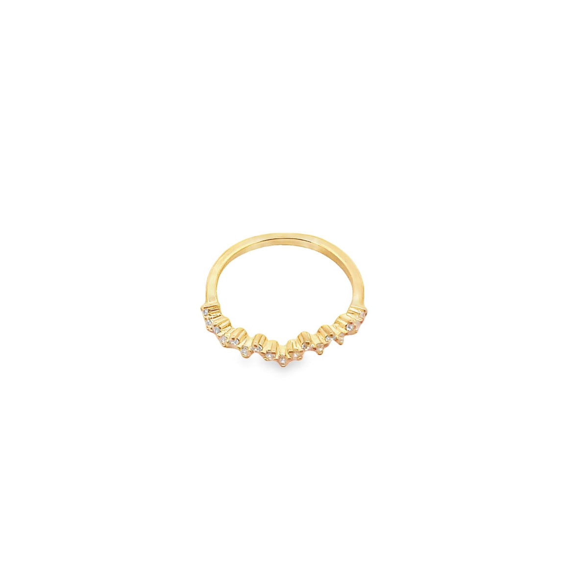 A delicate gold diamond ring rests against a clean white background, showcasing its sparkling pavé-set stones along a curved band.