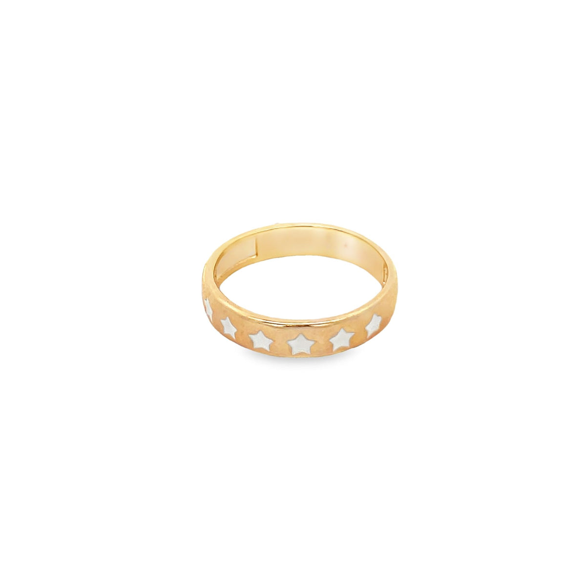A gold band ring features an engraved pattern of white enamel stars wrapping around its outer surface.