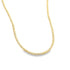 A minimalist gold beaded disk necklace rests against a plain white background.