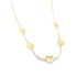 A delicate gold chain necklace dangles against a white background, featuring alternating heart charms and circular medallion pendants.