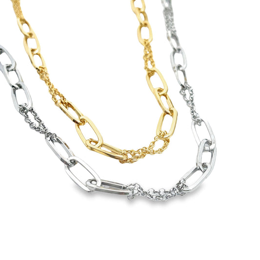 A two-tone layered necklace features interlocking gold and silver paperclip links against a clean white background.