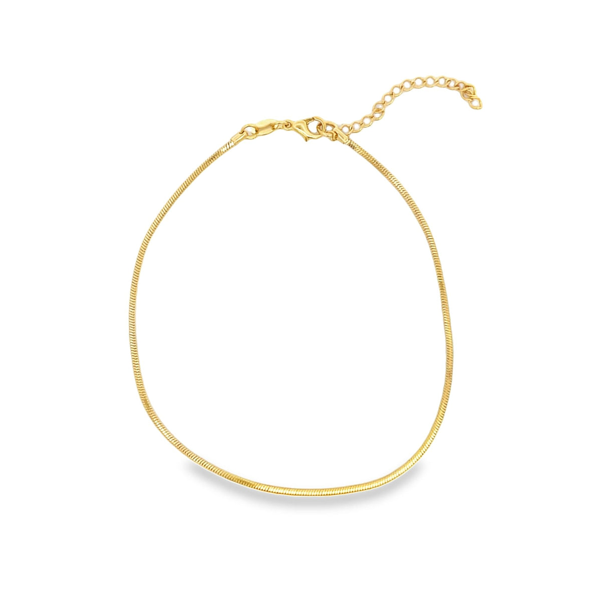 A delicate gold snake chain necklace curves gracefully on a clean white background.