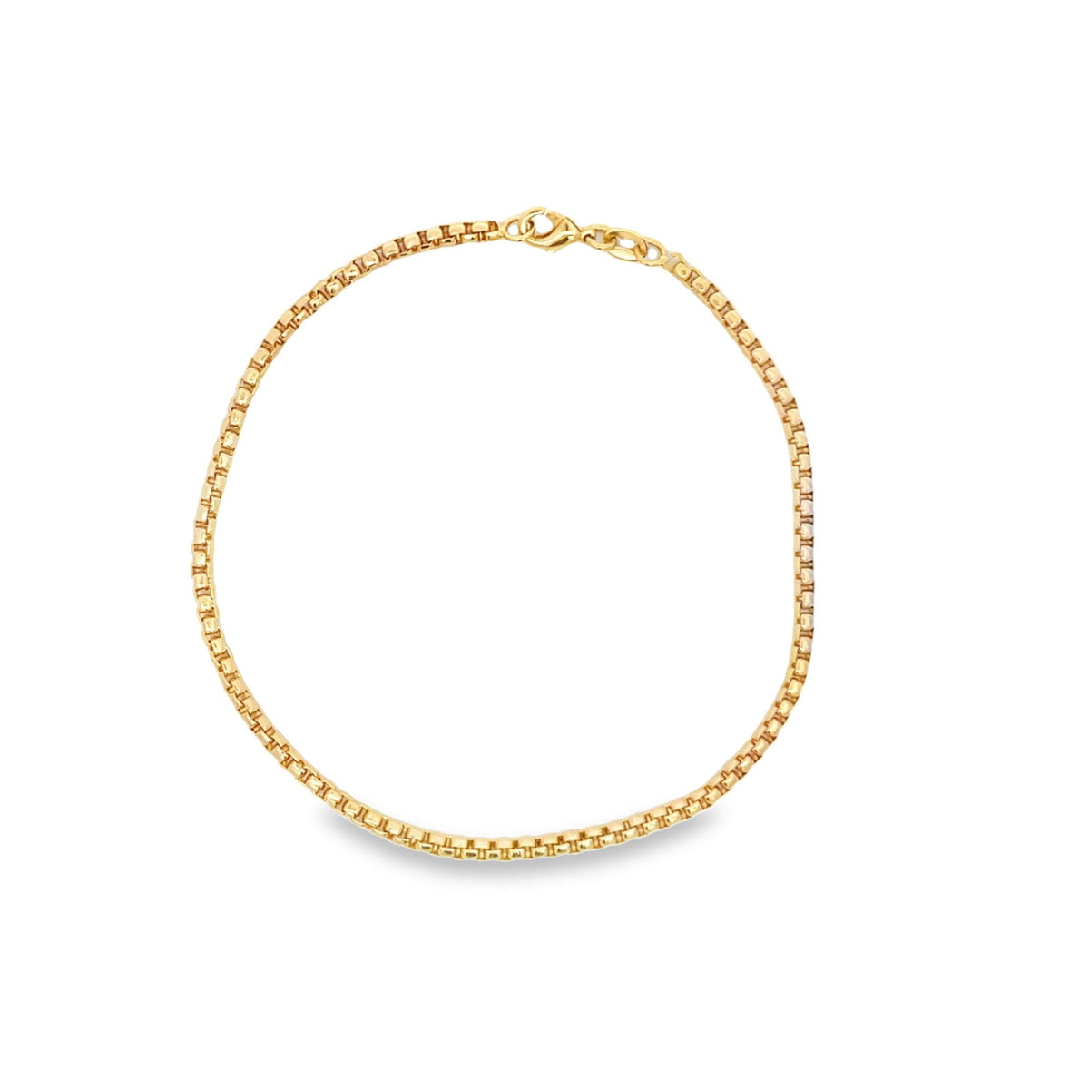 A gleaming yellow gold box chain necklace rests in a simple circle against a clean white background.