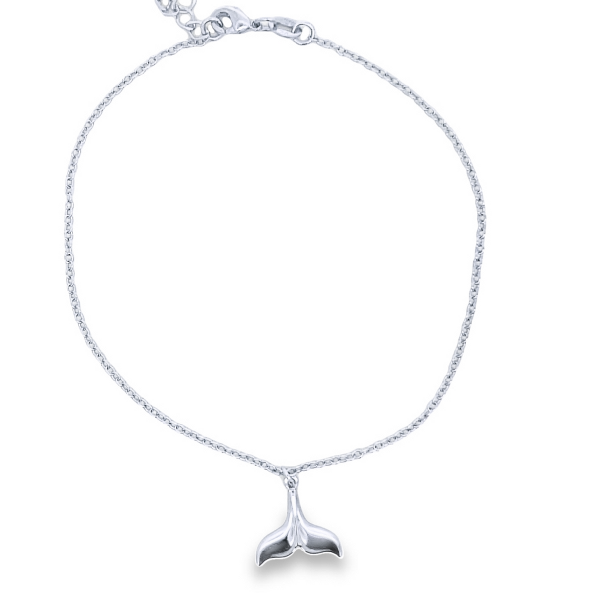 A delicate silver chain necklace features a polished whale tail pendant dangling from its center.
