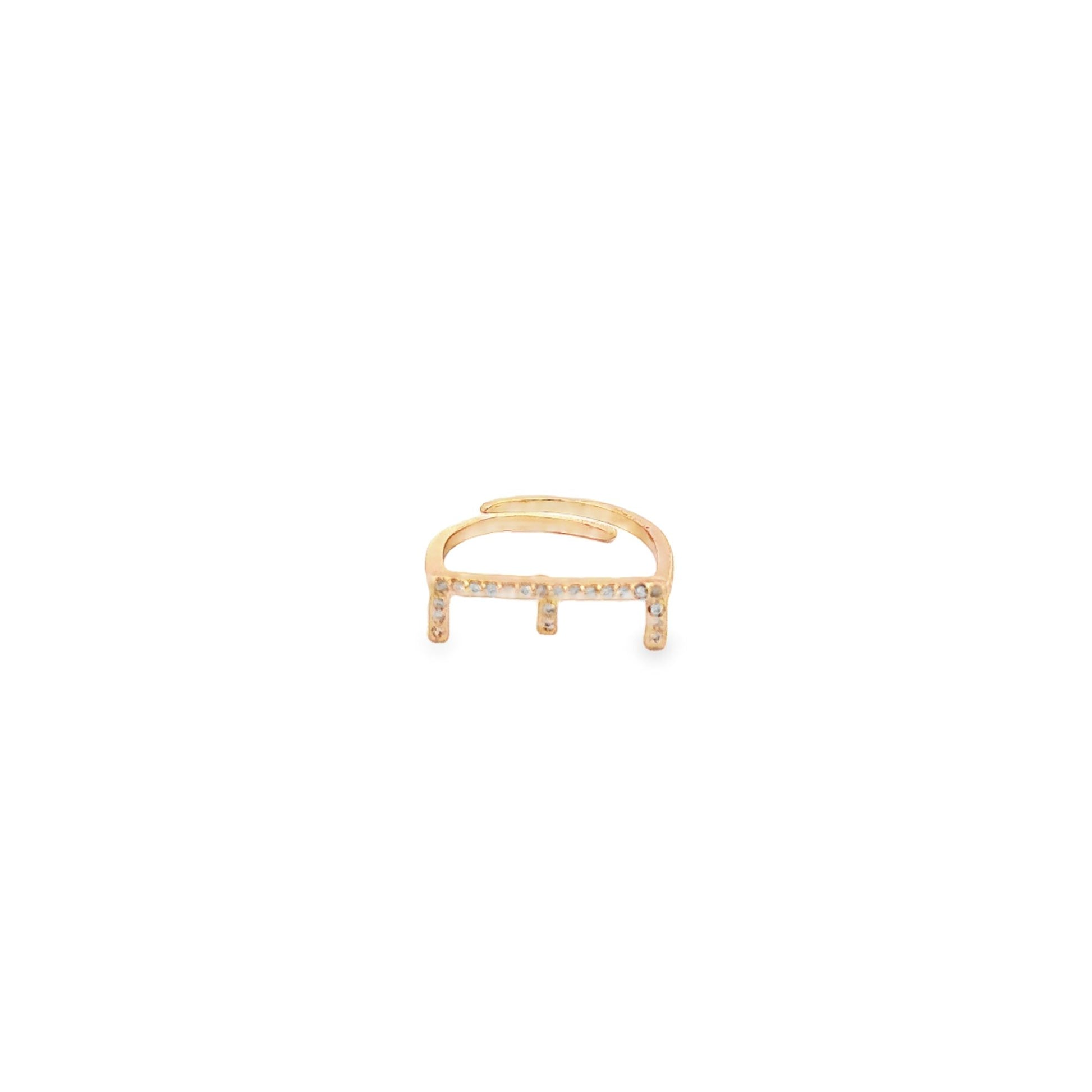 A delicate gold ear cuff embellished with sparkling pave diamonds sits against a white background.