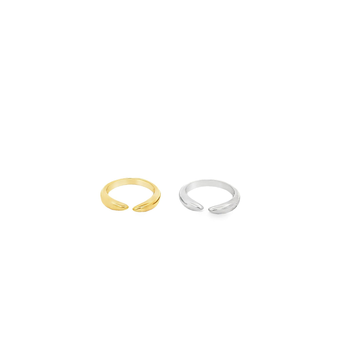 Two sleek open rings rest side by side on a clean white surface, showcasing a polished gold ring and a matching silver ring with tapered ends.