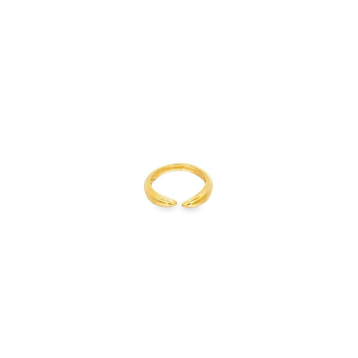 A minimalist gold ear cuff rests against a clean white background.