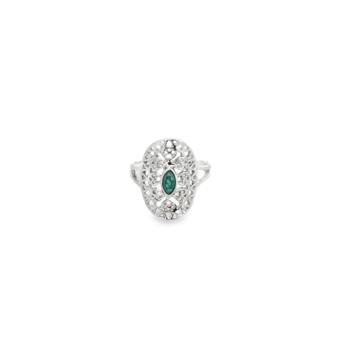 A vintage silver filigree ring features an oval-shaped green emerald stone centered in an intricate lace-like metal setting against a plain white background.