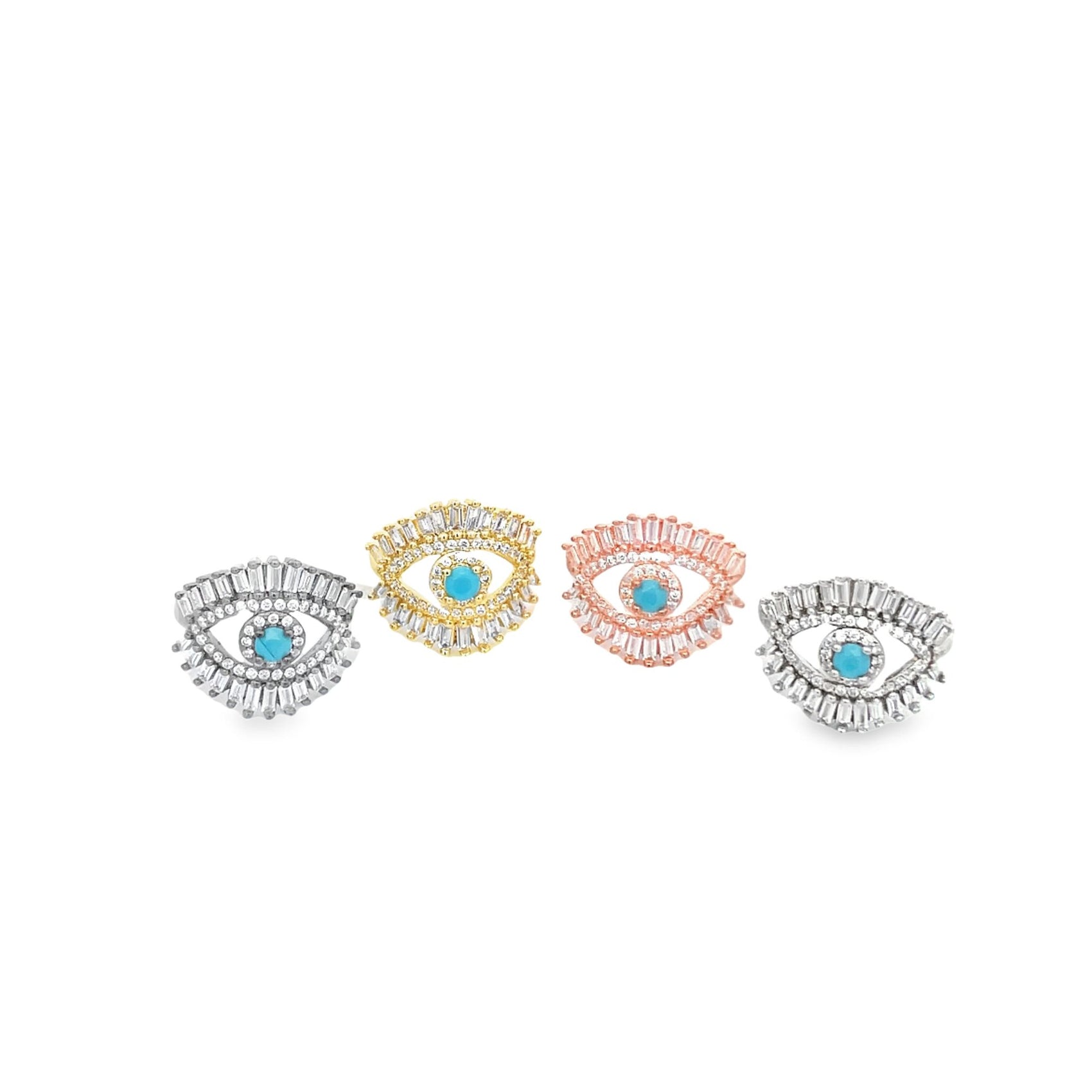 Four sparkling evil eye rings featuring central turquoise stones and baguette-cut cubic zirconia accents sit in a row against a white background.