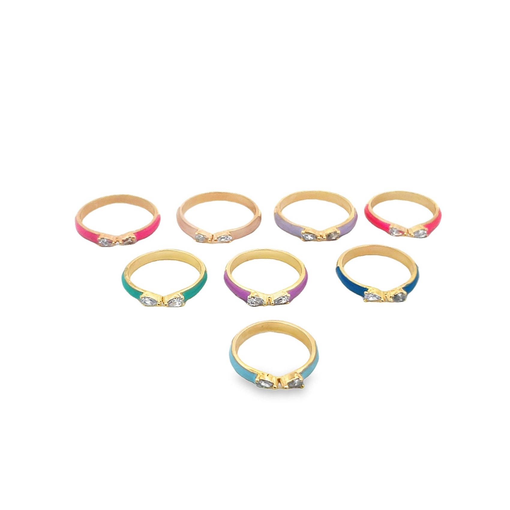 Seven colorful enamel gold rings with sparkling cubic zirconia bows rest on a clean white surface.