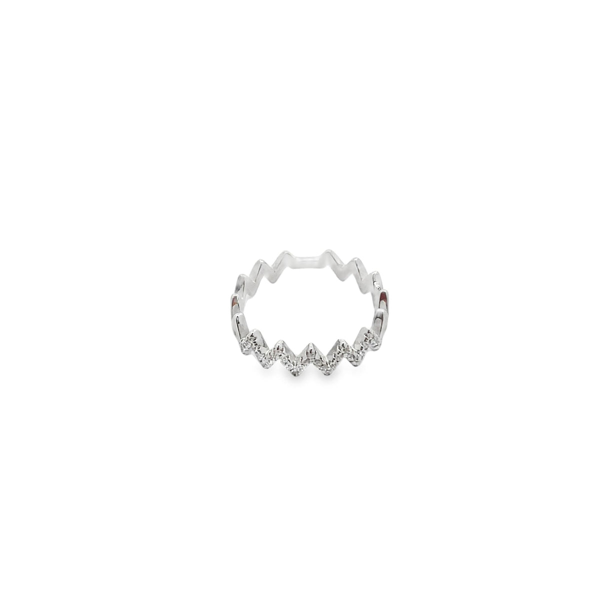 A silver zigzag ring sparkles with small diamonds set along its geometric band.