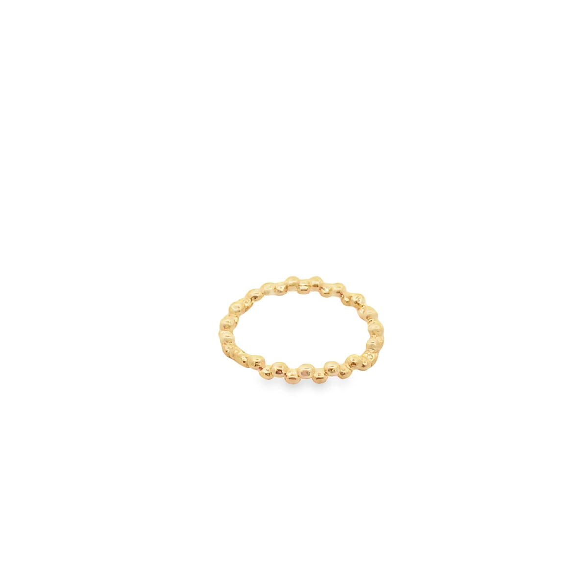 A delicate gold beaded ring rests against a clean white background.
