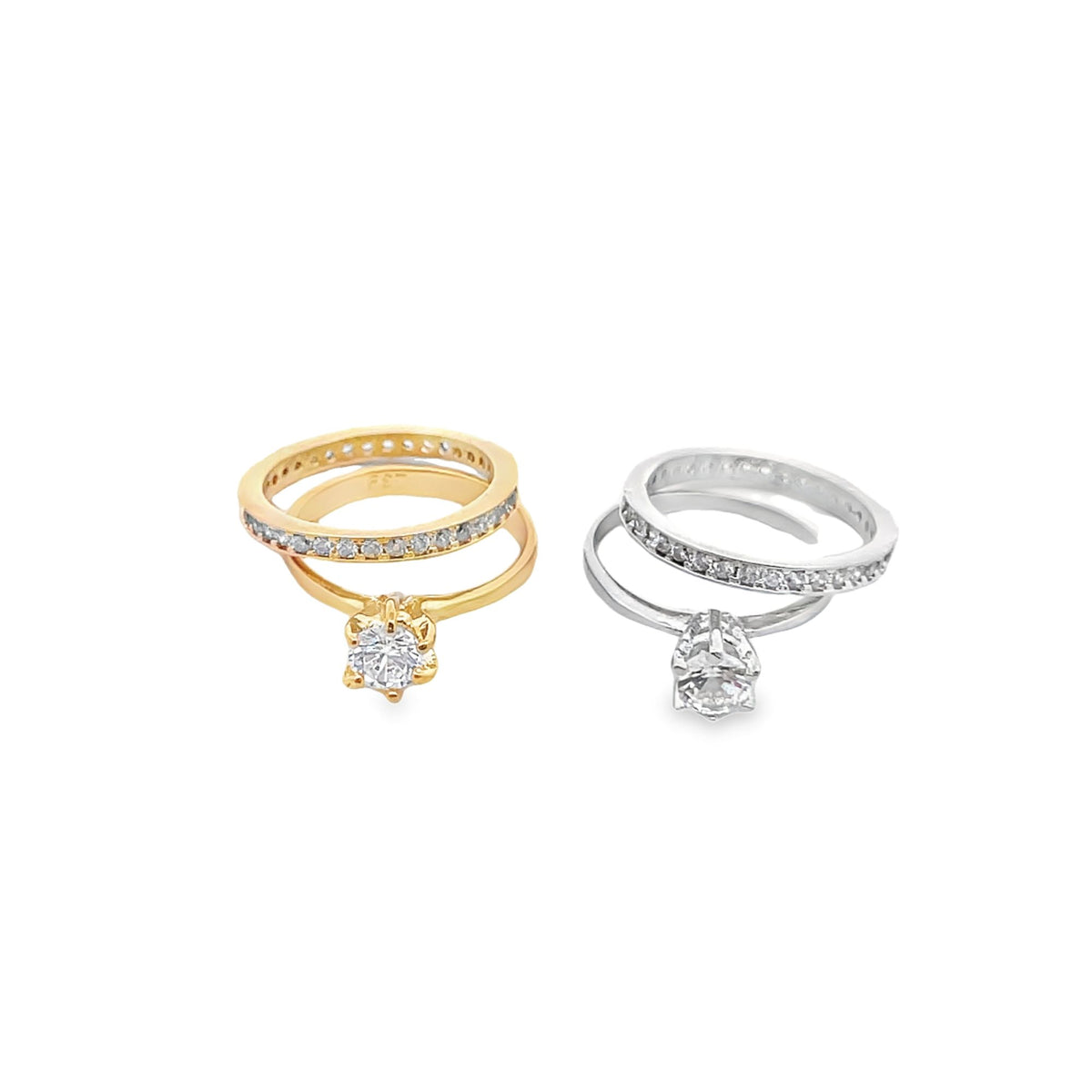 Two stacked diamond engagement rings in gold and silver display sparkling solitaire stones against a clean white background.
