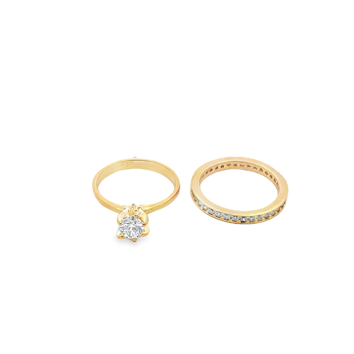 Two elegant gold diamond rings sit side by side against a clean white background.