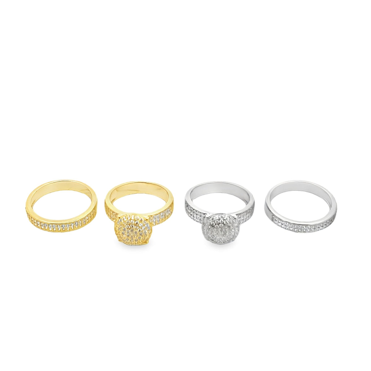 Four sparkling diamond rings, including two gold bands and two silver bands, rest in a row on a clean white surface.
