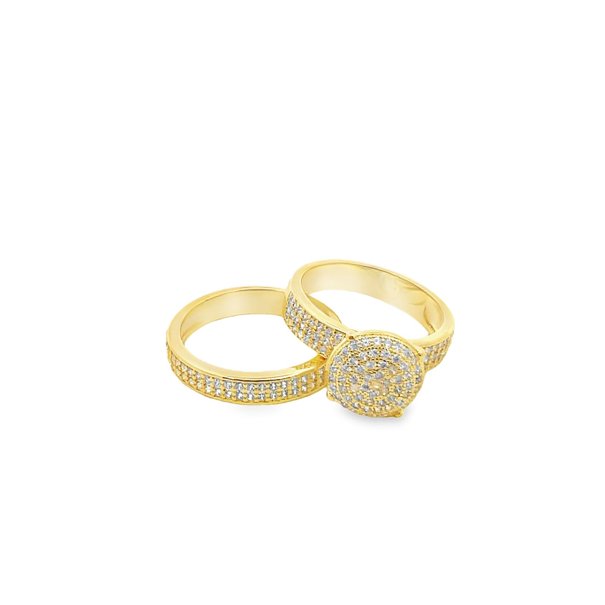 Two interlocking gold rings embellished with sparkling pave-set diamonds rest side by side on a clean white background.