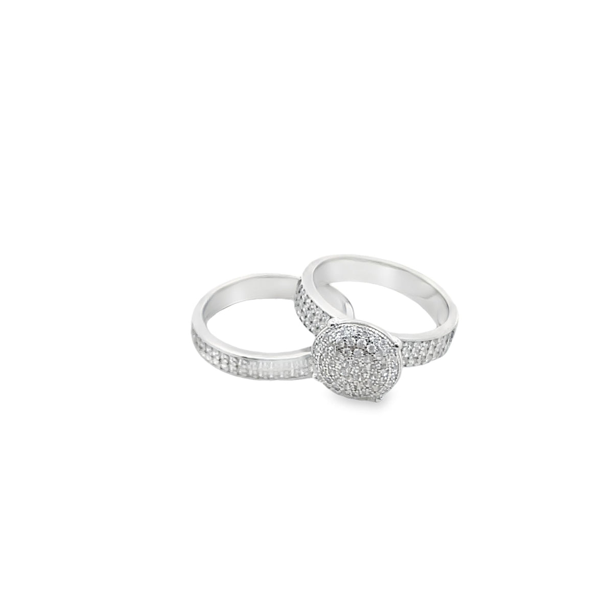 Two interlocking silver diamond engagement rings sparkle against a clean white background.