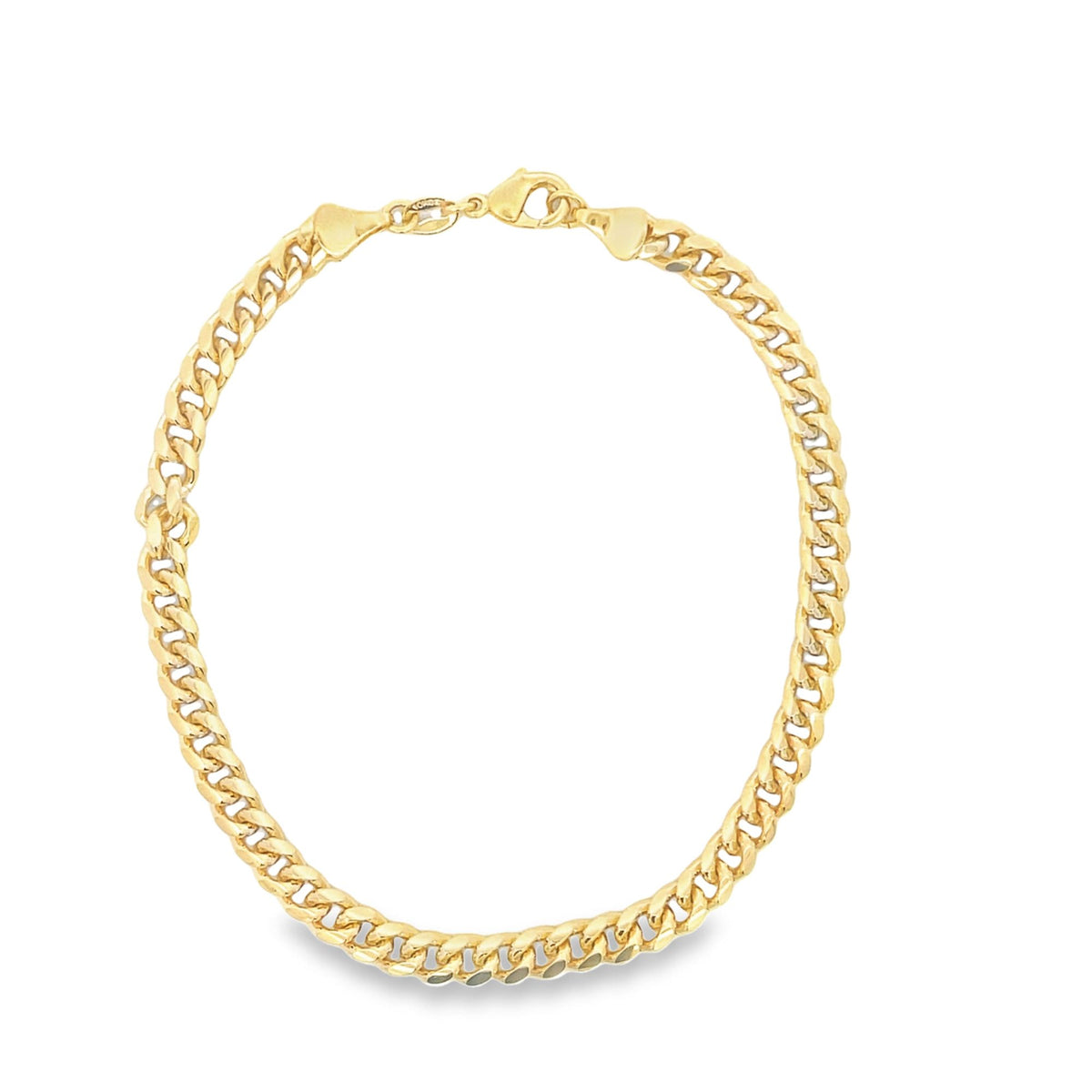A polished yellow gold curb link chain necklace curves gracefully against a plain white background.
