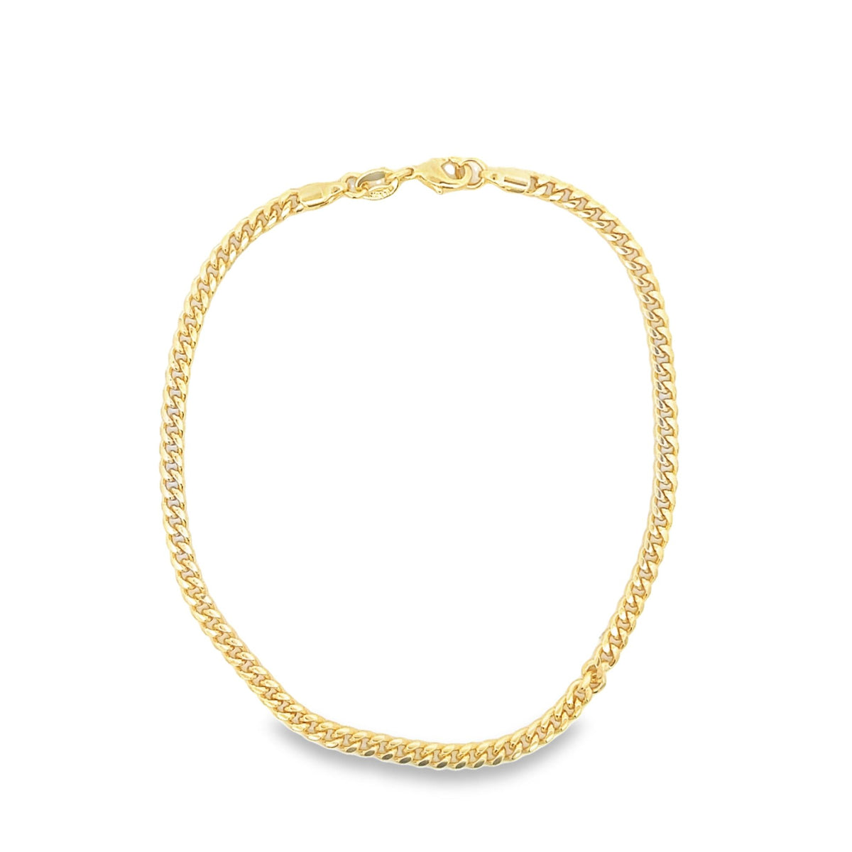 A classic yellow gold cuban link chain necklace rests in a circle on a clean white background.