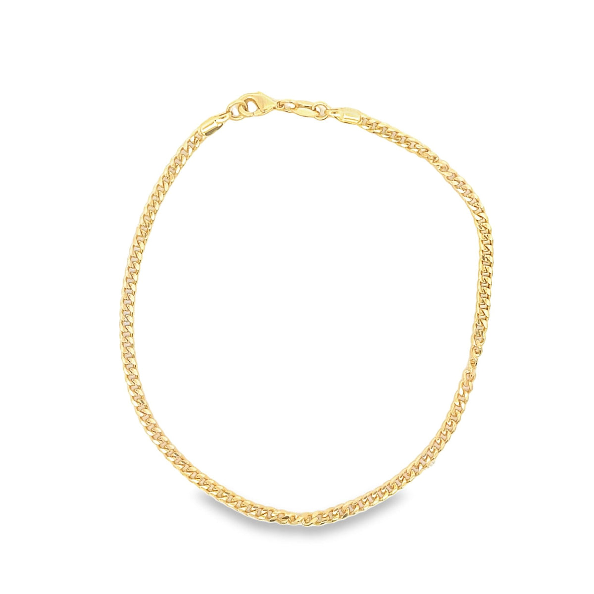 A gleaming gold curb chain anklet rests in a simple circle against a clean white background.