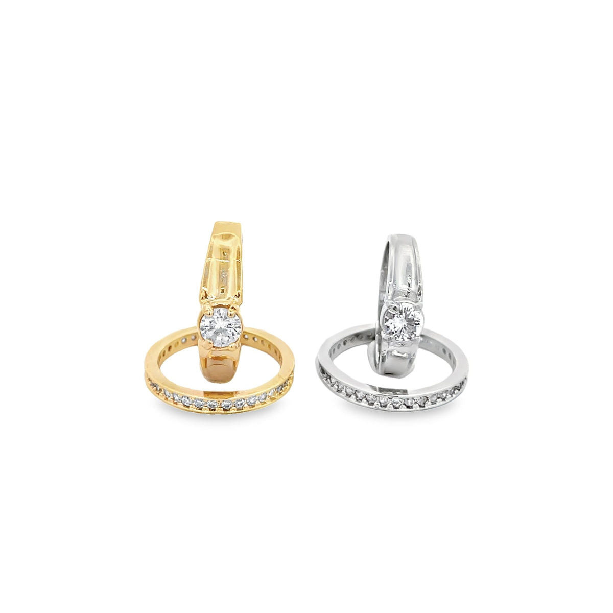 Two diamond-encrusted rings, one in yellow gold and one in silver, stand upright next to each other on a white background.