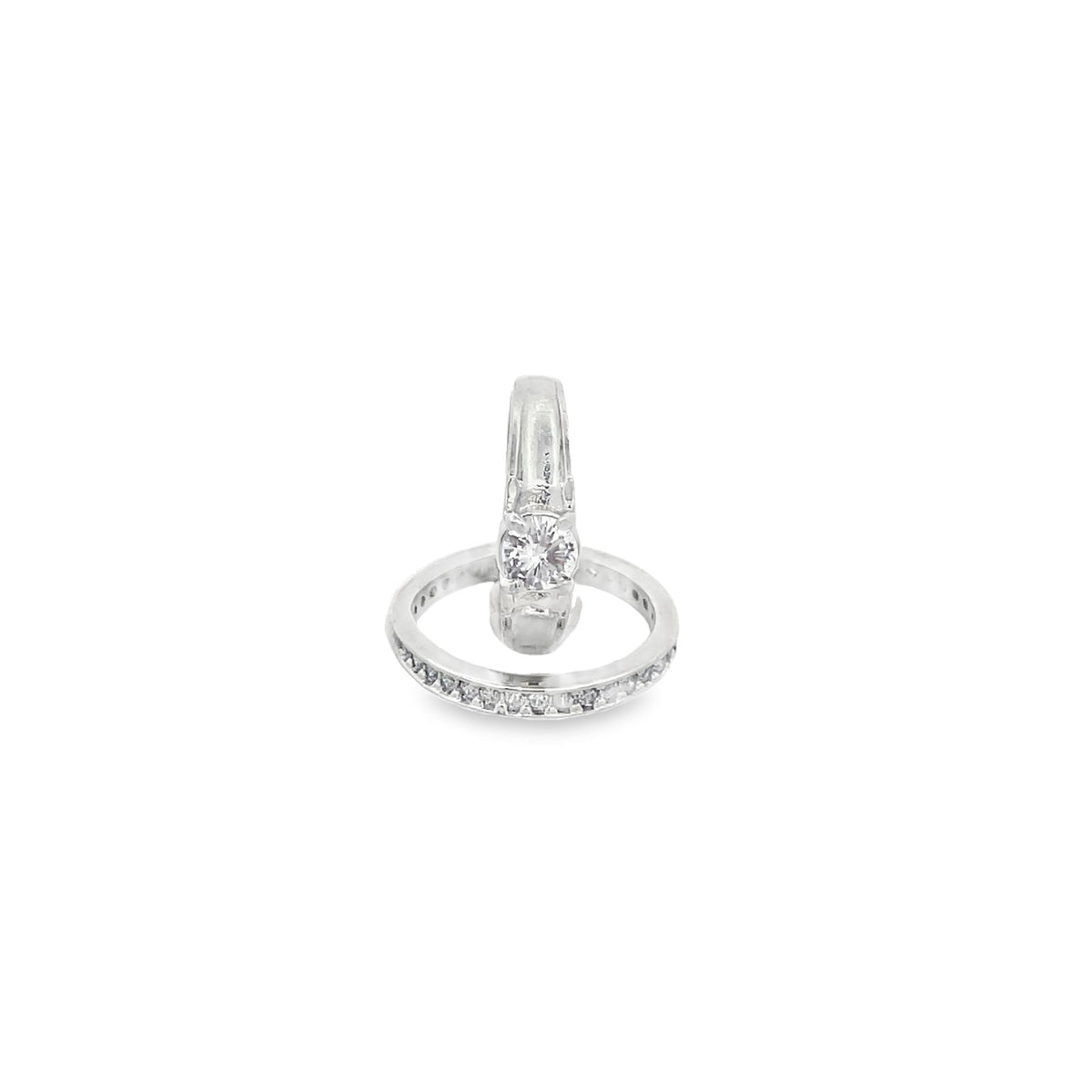 A gleaming diamond engagement ring rests inside a sparkling white gold band against a pure white background.