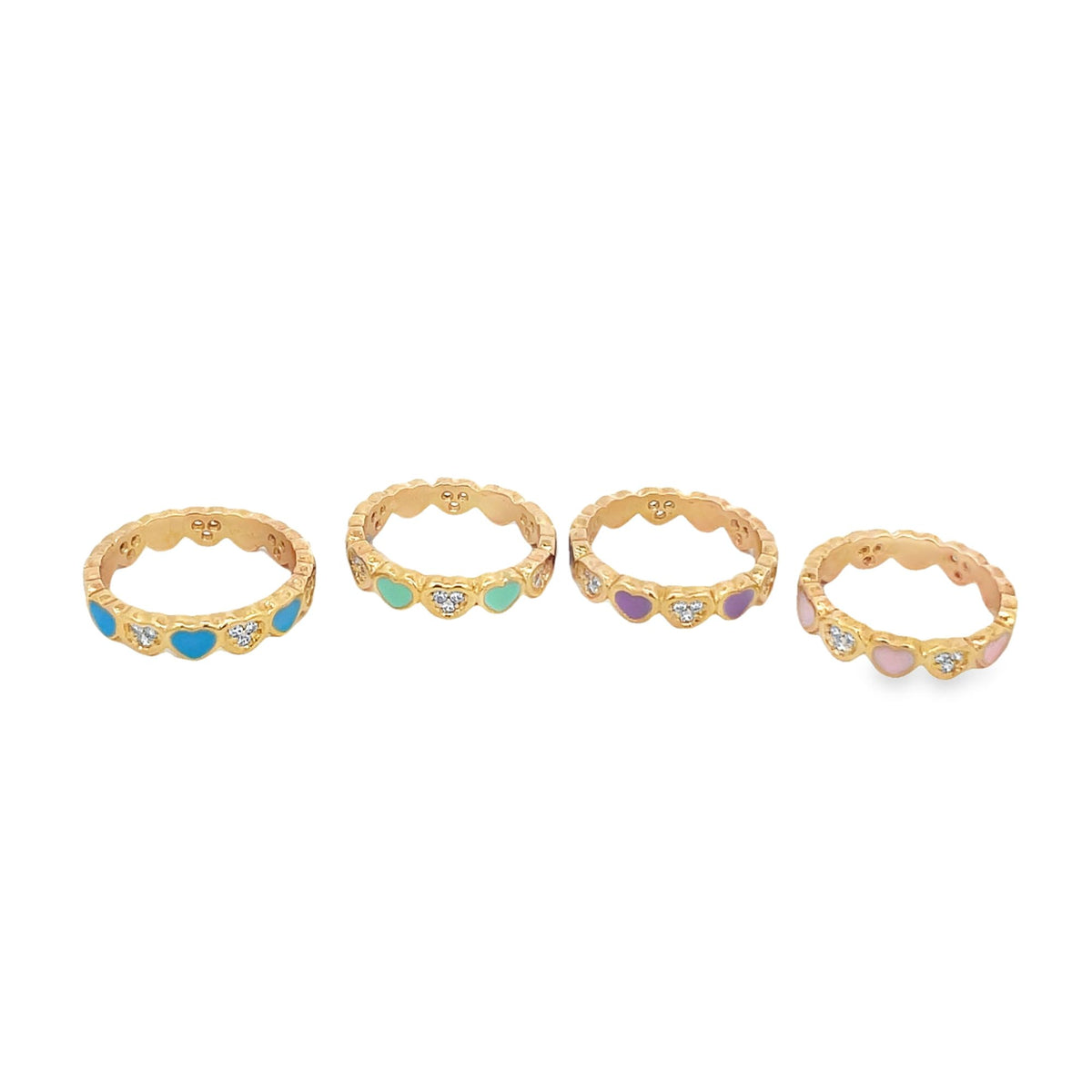 Four gold heart-patterned rings with colorful enamel and cubic zirconia accents sit in a row on a white background.