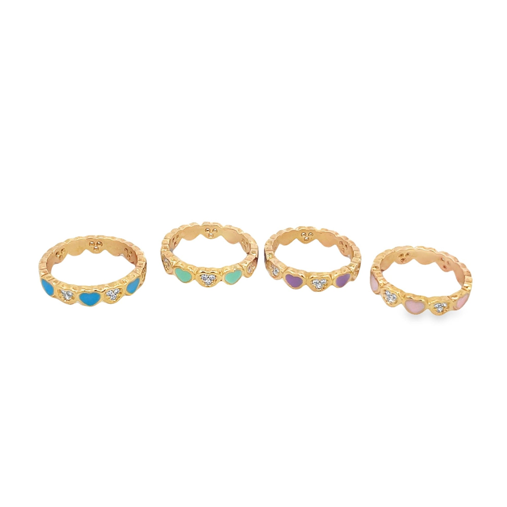 Four gold heart-patterned rings with colorful enamel and cubic zirconia accents sit in a row on a white background.