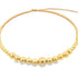 A delicate gold bead bracelet features a string of polished spherical beads graduating in size toward the center, displayed against a clean white background.