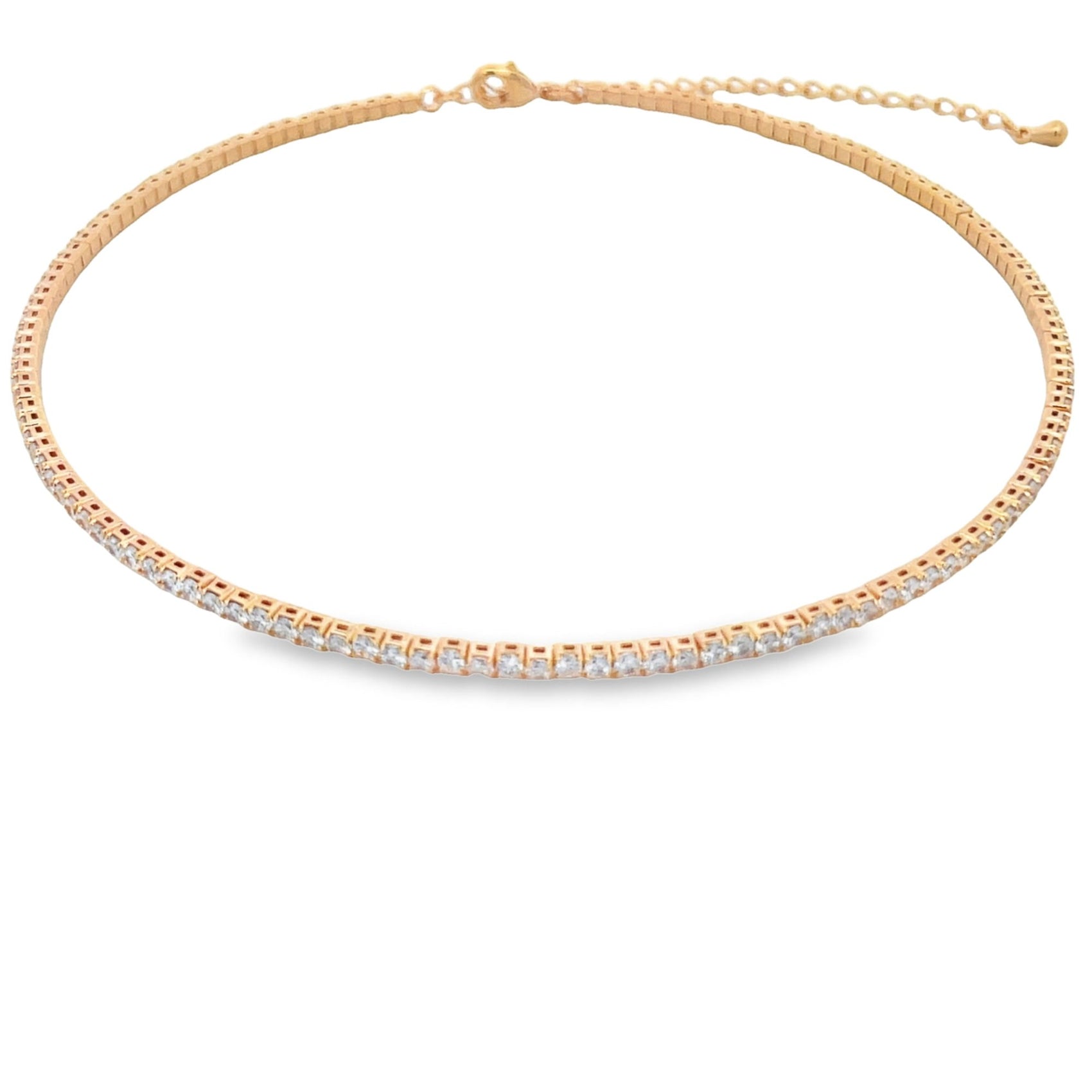 A gold tennis choker necklace featuring a continuous line of sparkling square-cut cz stones rests flat against a white background.