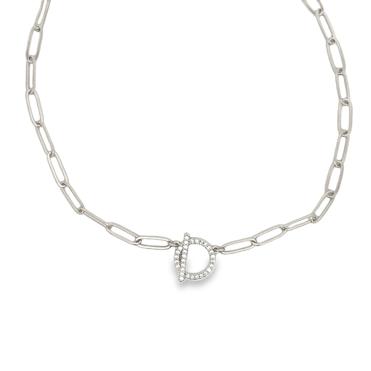 A silver paperclip chain necklace features a sparkling initial D pendant set with small cubic zirconia stones.