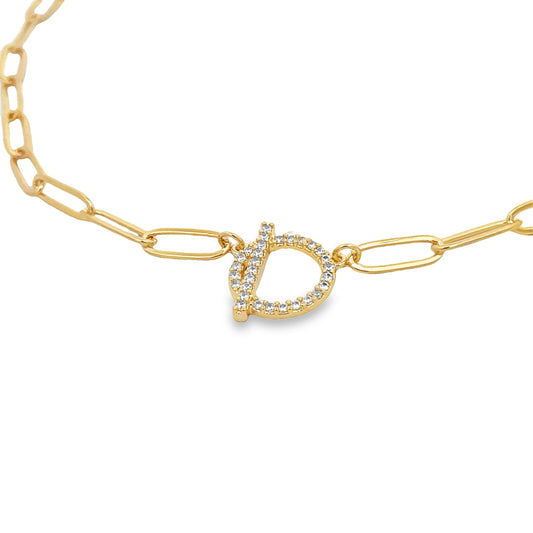 A gold chain necklace features a sparkling initial letter D pendant encrusted with pave diamonds.