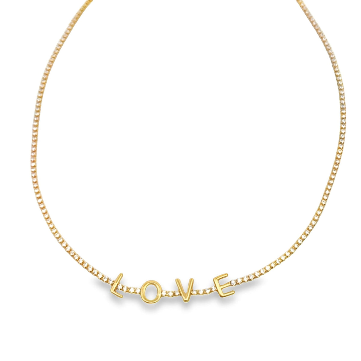 A delicate gold tennis necklace features diamond accents and spells out the word "LOVE" in sparkling letters.