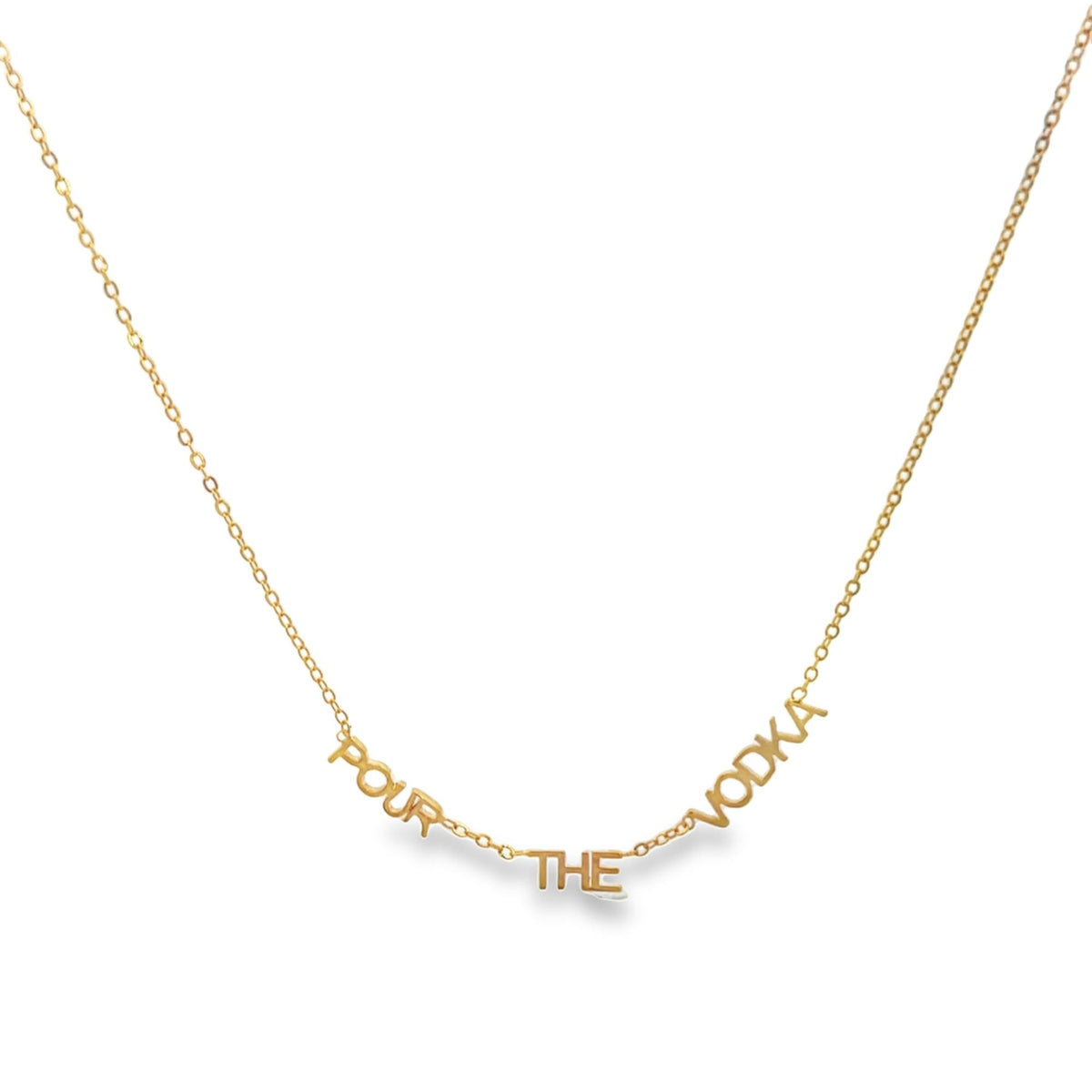 A delicate gold chain necklace spells out the phrase "Pour the Vodka" in block letters.