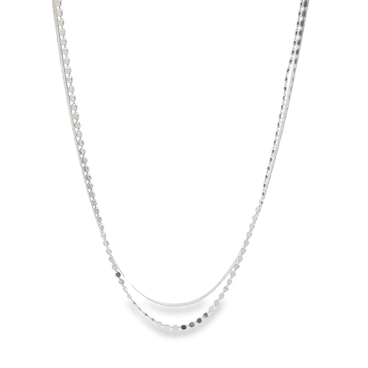 A delicate silver layered necklace features a beaded chain and a sleek snake chain draped elegantly against a plain white background.