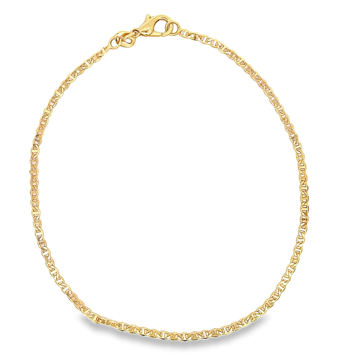 A delicate gold anklet with a textured mariner link chain curves gracefully on a white background.