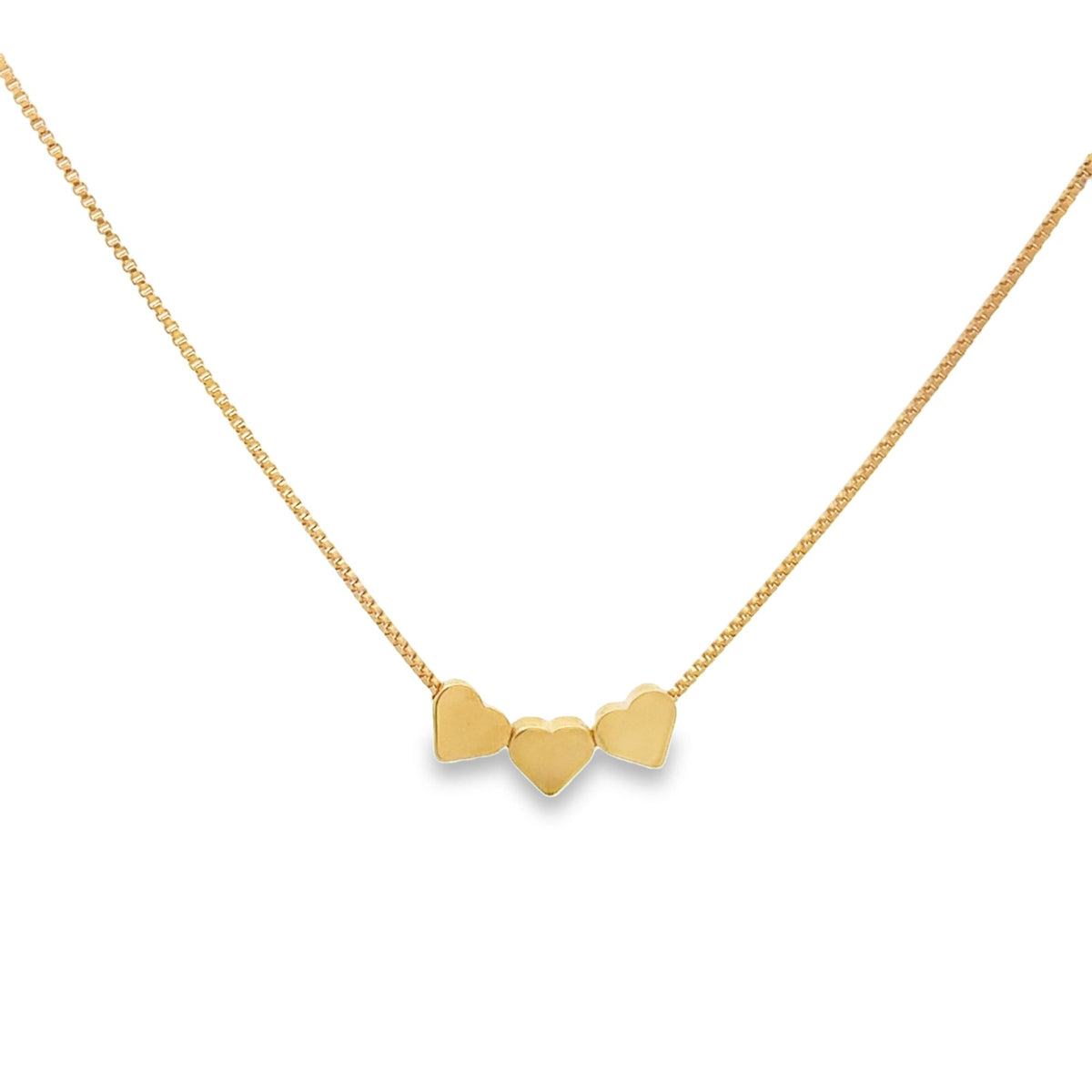 A delicate gold chain necklace showcases a trio of polished heart pendants dangling together.