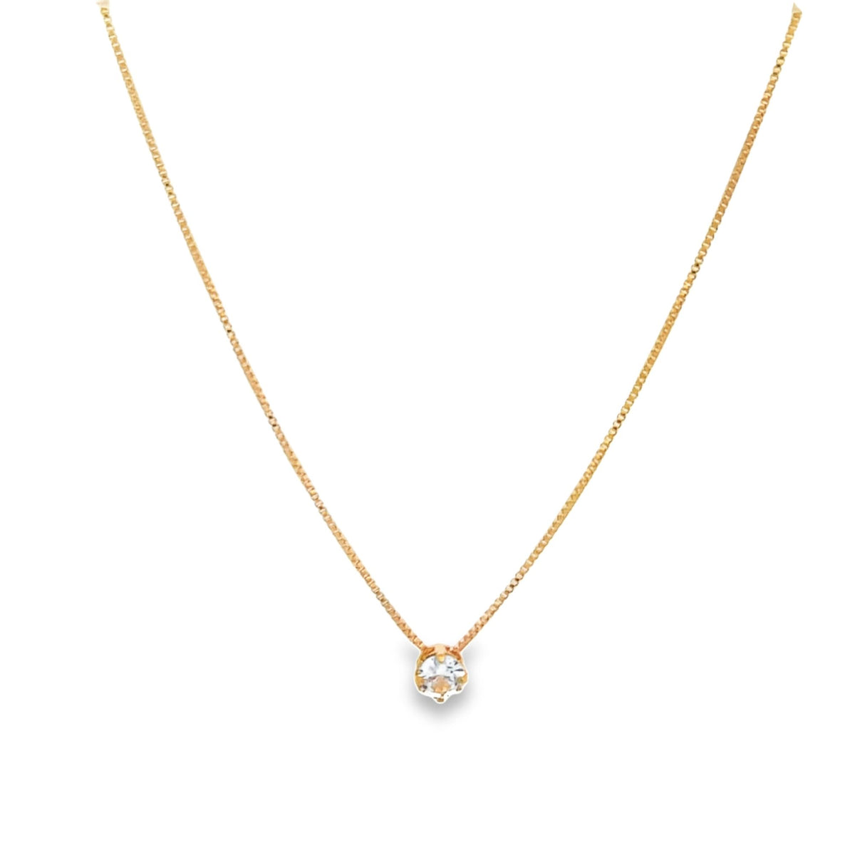 A delicate gold chain necklace features a single sparkling solitaire diamond pendant against a plain white background.