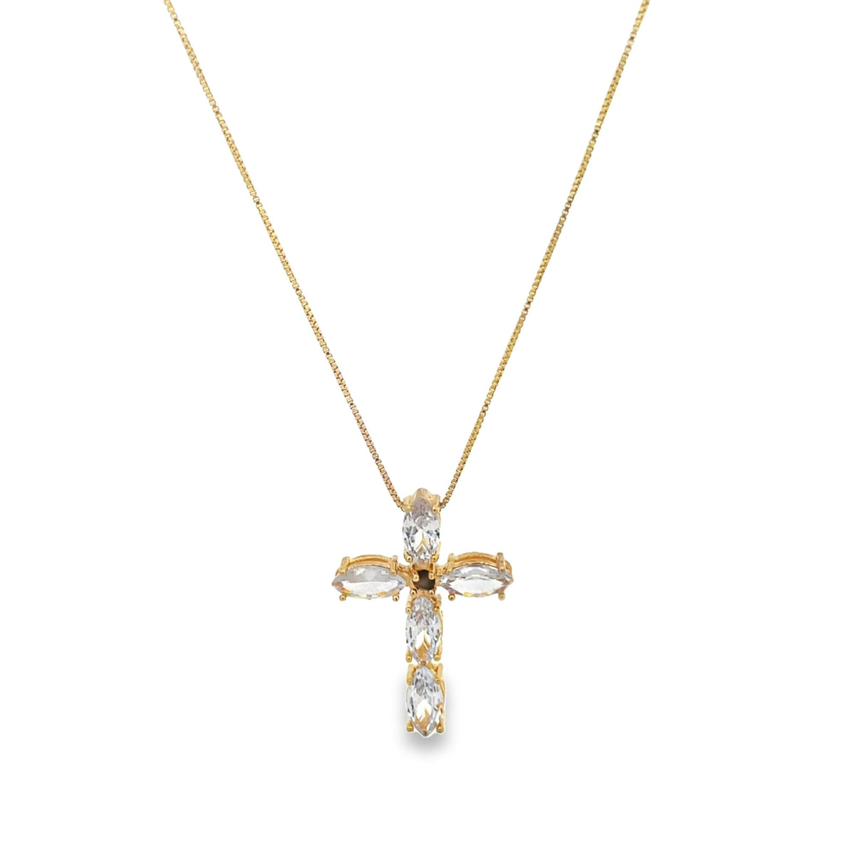 A delicate gold chain holds a sparkling crystal cross pendant against a plain background.