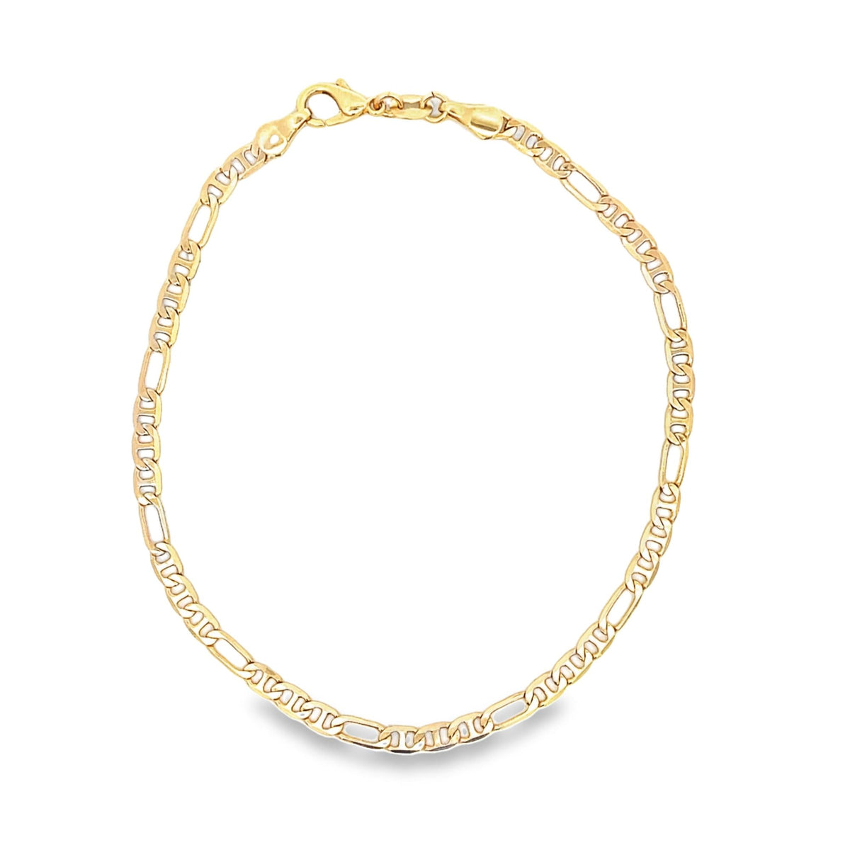 A polished gold Figaro link chain bracelet curves against a clean white background.