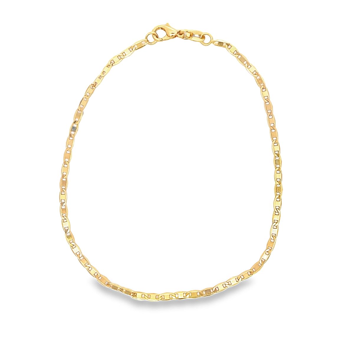 A delicate gold chain necklace lies in a gentle oval shape against a plain white background.
