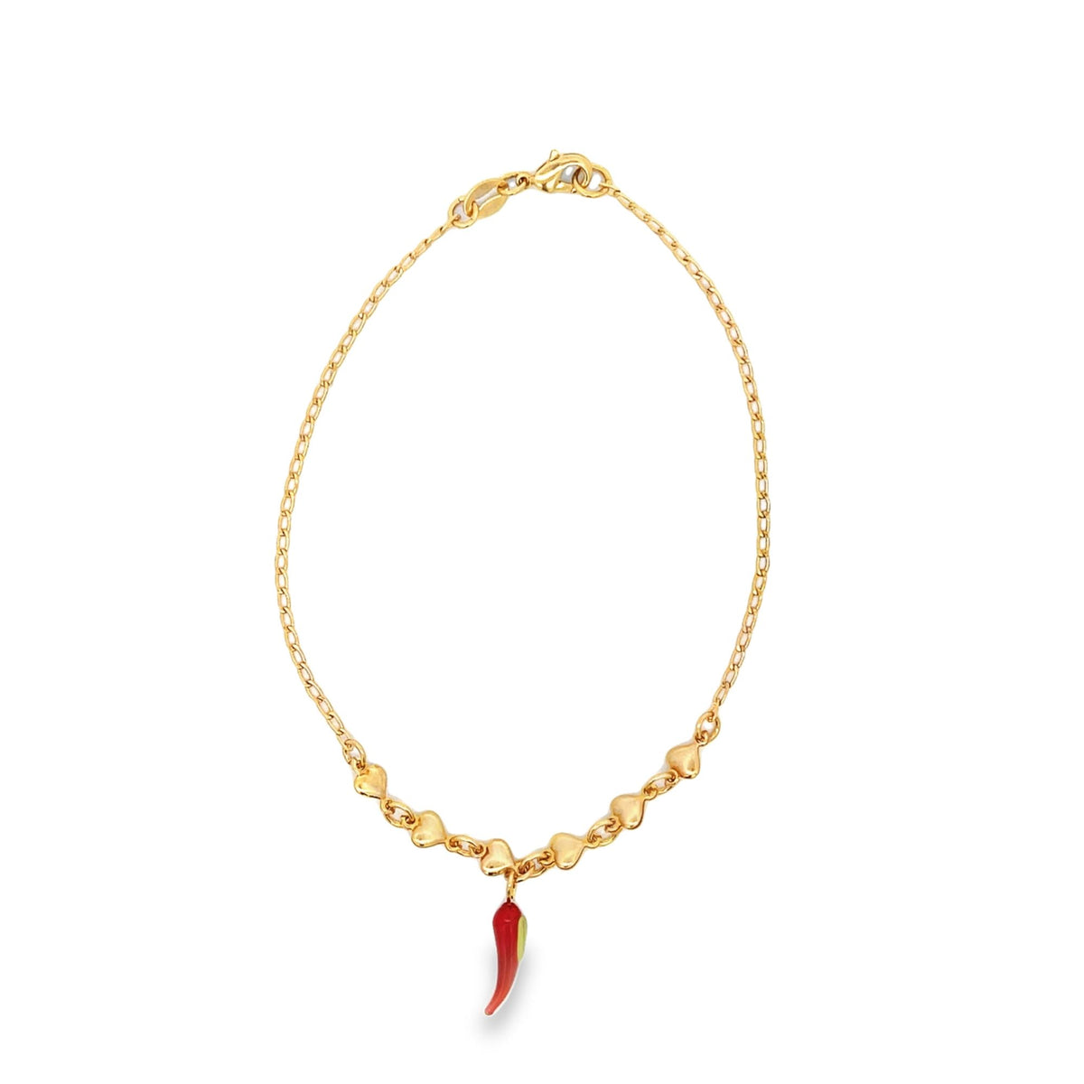 A delicate gold chain bracelet features small heart-shaped links and dangles a vibrant red enamel chili pepper charm against a clean white background.