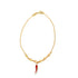 A delicate gold chain bracelet features small heart-shaped links and dangles a vibrant red enamel chili pepper charm against a clean white background.