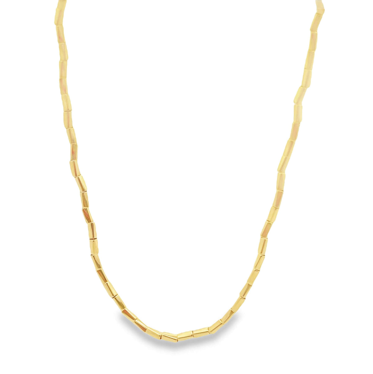 A delicate gold tube bead necklace rests against a clean white background.