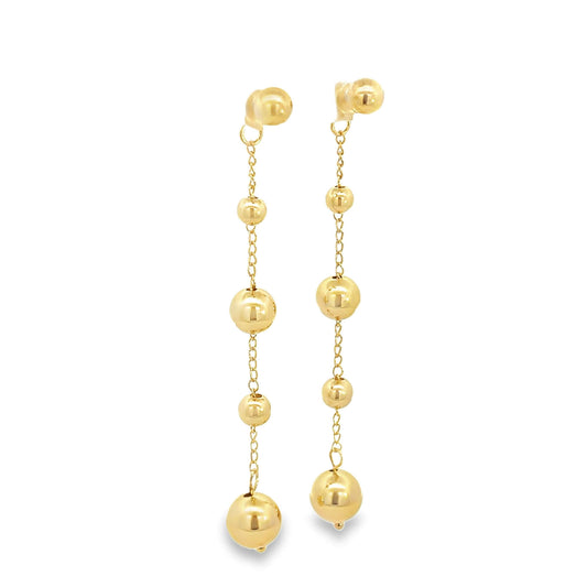 A pair of dangling gold earrings features alternating delicate chains and polished spherical beads of varying sizes.