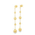 A pair of elegant long gold dangle earrings features delicate chains interspersed with polished bead spheres of graduating sizes.