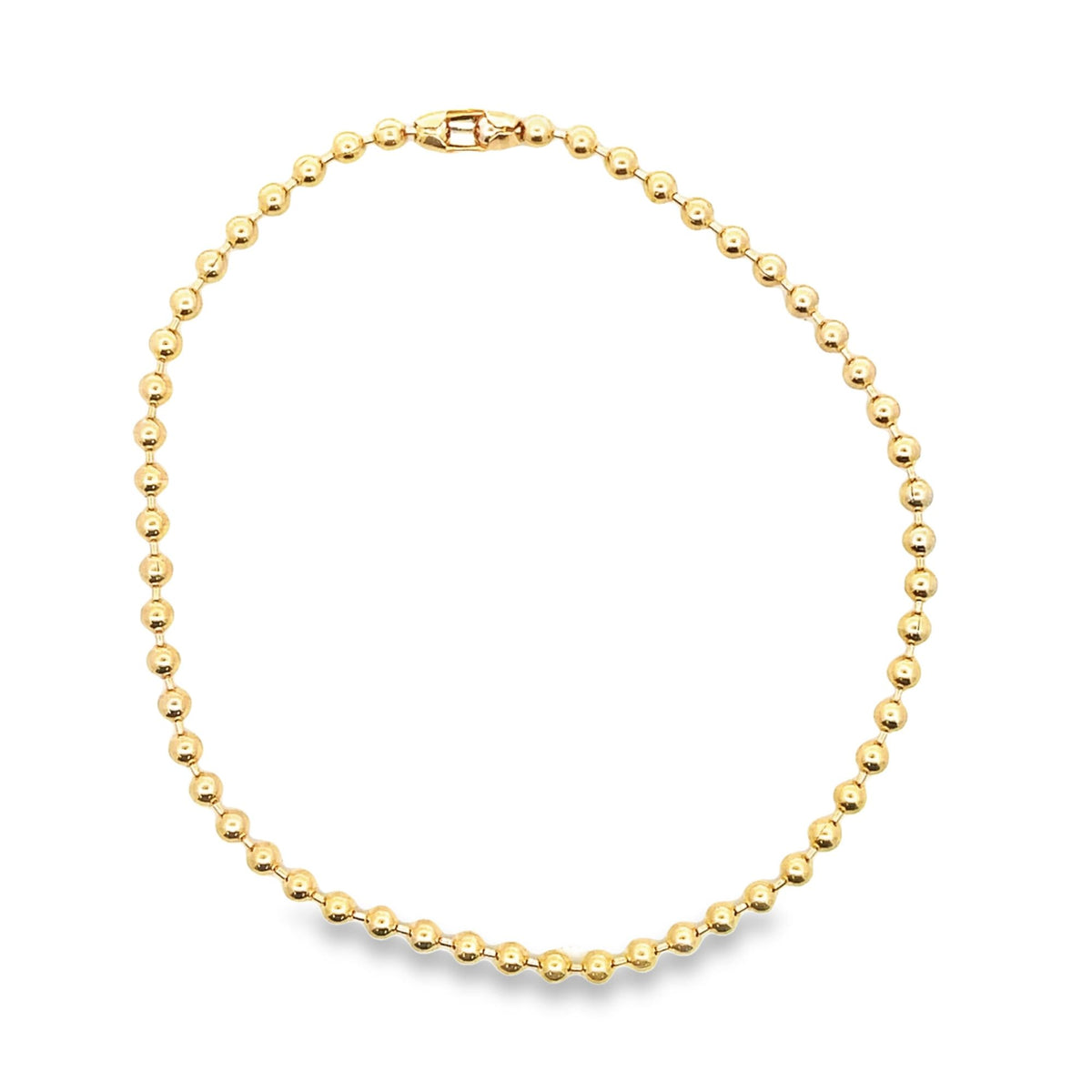 A polished yellow gold ball chain necklace lies in a circular shape against a clean white background.