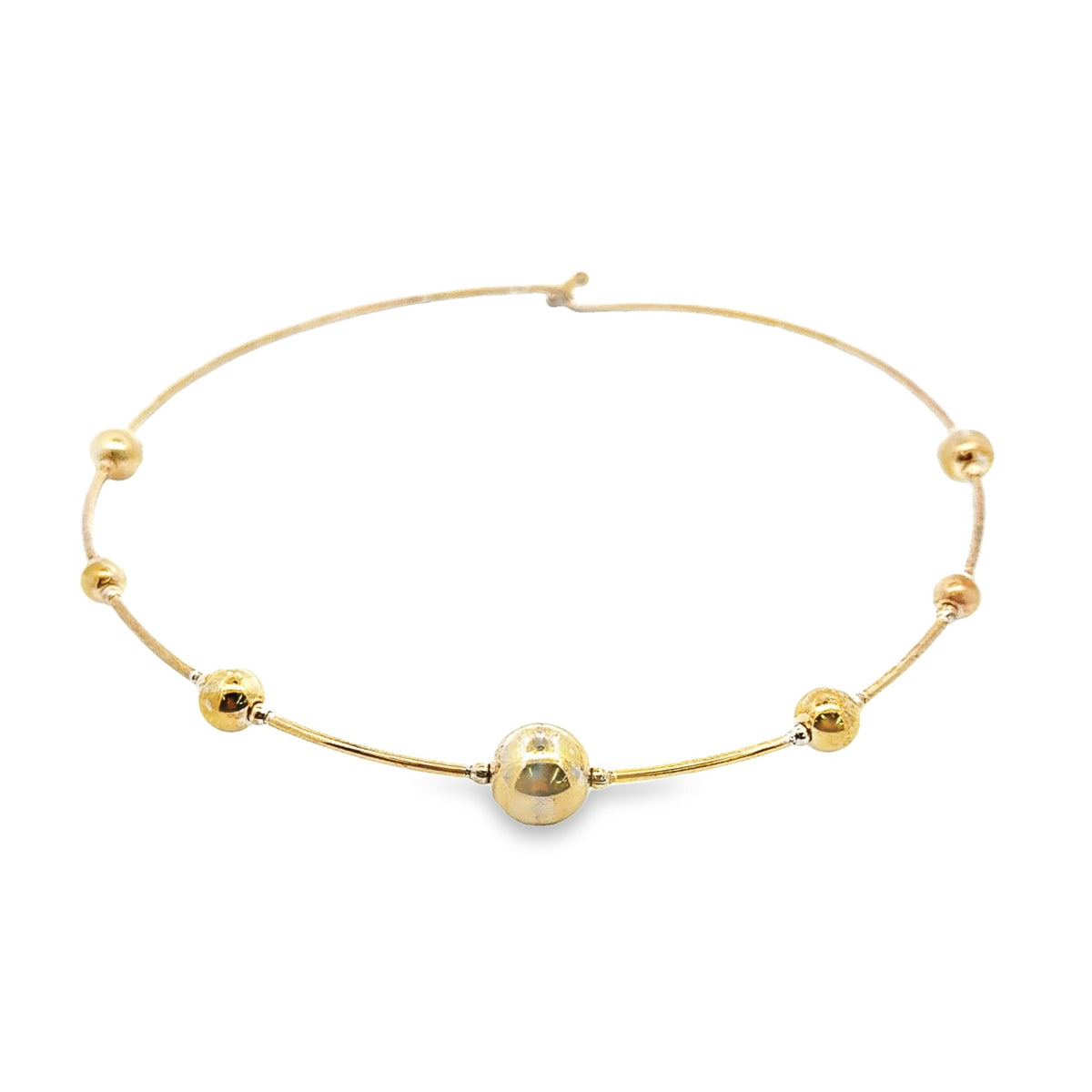 A sleek yellow gold choker necklace features evenly spaced polished beads along its delicate wire.
